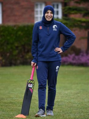 Girl in Cricket Scotland attire doing a regular pose